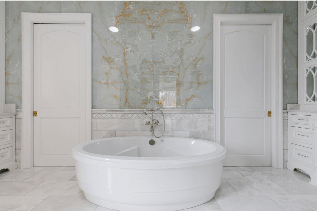 Bookmatched thin stone panel bathroom with marble walls and vanity by Designer Stone Panels — project 8