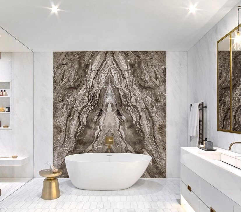 Book-matched Calacatta marble shower wall installation