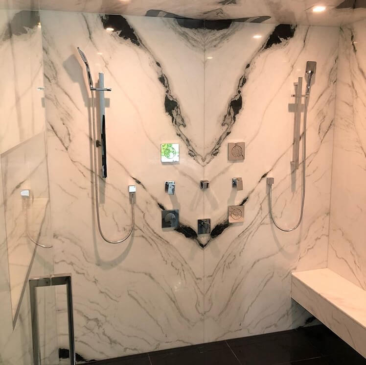 Bookmatched thin stone panel bathroom with marble walls and vanity by Designer Stone Panels — project 10